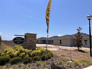 A construction site with developing homes and landscaped surroundings in Spirit Landings by KB Home (Winter Haven, FL).