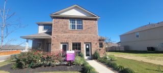 Charming two-story brick home with manicured landscaping in Abbott Place by Legend Homes (St. Hedwig, TX).
