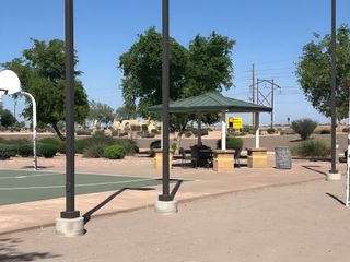 Community amenities with a basketball court and shaded seating in Magnolia at Desert Passage by KB Home (Maricopa, AZ).
