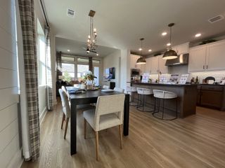 A sophisticated open-concept kitchen and dining space with elegant finishes in Solterra by David Weekley Homes (Mesquite, TX).