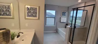 A sophisticated bathroom featuring a clean design, including a bathtub, separate shower, and tasteful decor.