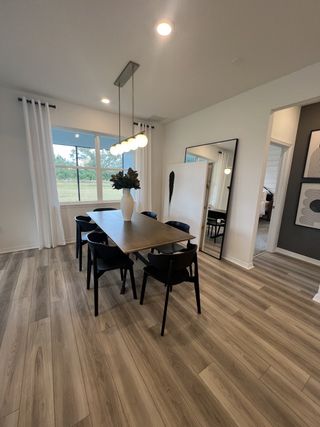 Model Home A cozy dining space with a minimalist design, elegant lighting, and large windows for natural views.