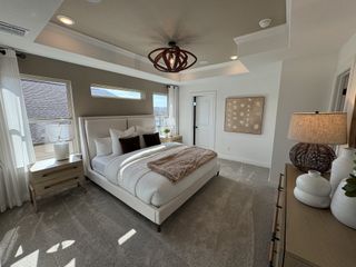 Model Home A serene bedroom featuring a Hanson Upholstered Low Profile Bed, complemented by neutral tones, recessed lighting, and stylish decor.