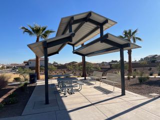 A community pavilion with benches and tables in Ventana de Estrellas Enclaves by KB Home, Goodyear, AZ.