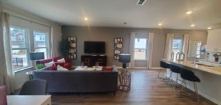 A modern open-concept living space with stylish furnishings, sleek flooring, and ample natural light.