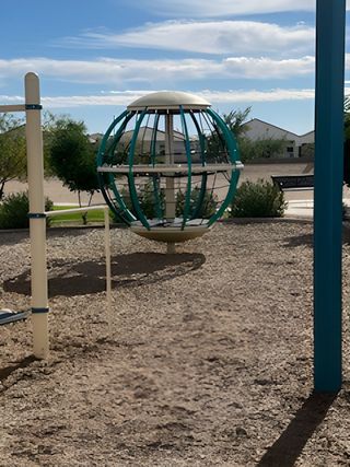 A scenic community playground in Rio Rancho Estates by D.R. Horton, featuring unique play structures in Surprise, AZ.