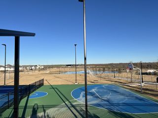 Community Amenities A scenic sports park featuring basketball and soccer courts with breathtaking open views in Harvest Ridge by Brohn Homes (Elgin, TX).