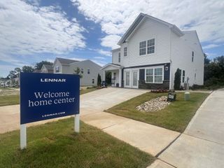 A modern white home with landscaped yard in The Retreat At Cameron Commons by Lennar, Charlotte, NC.