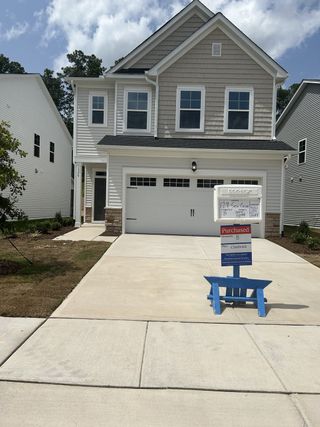 A charming two-story home with a modern design and spacious driveway in Edge of Auburn by Lennar (Raleigh, NC).