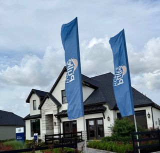A charming home with dark roofing and stone accents in Katy Court by Pulte Homes (Katy, TX).