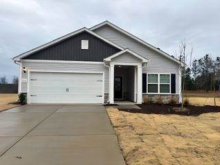 Street view A charming contemporary home with a spacious driveway and neat lawn in The Meadows at Oxford by LGI Homes (Oxford, NC).