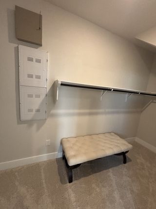 A spacious walk-in closet with shelving, a built-in bench, and plush carpeting for ultimate convenience.