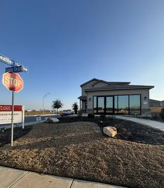 A modern model home with large glass windows, clean landscaping, and signage for View Homes in Blue Ridge Ranch (San Antonio, TX).