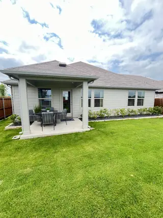 Street view A charming home with a cozy patio and lush lawn in Simpson Crossing - Signature Series by Meritage Homes (McKinney, TX).