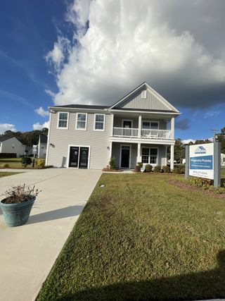 A charming two-story home with a manicured lawn in Magnolia Pointe by Eastwood Homes, North Charleston, SC.