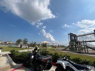 Community Amenities A vibrant community park with a modern playground, shaded seating, and a sparkling pool at Sterling Point at Baytown Crossings by Lennar (Baytown, TX).