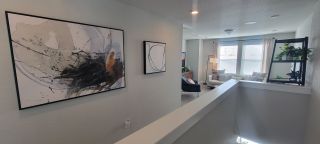A modern, light-filled living space with abstract art and contemporary decor.