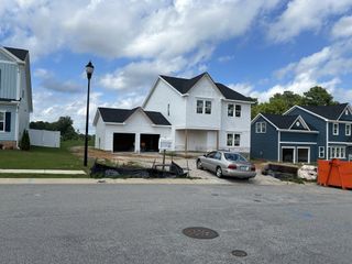 Street view Charming white two-story home under construction in Elizabeth Springs by ExperienceOne Homes, LLC (Wake Forest, NC).