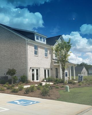 A charming light brick home with landscaped greenery in Briar Creek by Pulte Homes (College Park, GA).