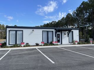 A modern, sleek office building with clean lines and a landscaped front in Ashley Walk Townes by Beazer Homes (Charleston, SC).