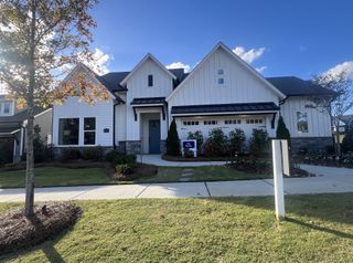 Street view A beautiful modern home with a blue door and manicured landscaping in Esplanade at Northgate by Taylor Morrison (Indian Trail, NC).