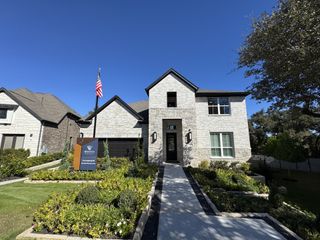A stunning stone facade with manicured landscaping in Anthem by Scott Felder Homes (Kyle, TX).