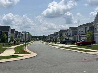 Street view A picturesque neighborhood view in Eckley by Tri Pointe Homes, showcasing modern homes on a serene street in Mooresville, NC.
