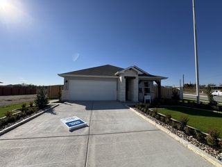 Street view A charming stone-accented home with a tidy lawn in Eastern Wells by Meritage Homes (Jarrell, TX).