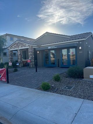 A charming stone-accented home with desert landscaping in Allen Ranches: Fiesta Collection by Taylor Morrison (Litchfield Park, AZ).