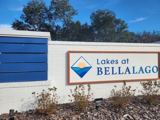 Street view A welcoming entrance sign for Lakes at Bella Lago by Mattamy Homes in Green Cove Springs, FL, set against a clear sky.