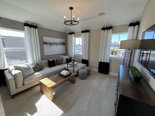 A cozy living room with a plush sectional, stylish wood coffee table, and modern art accentuate the inviting space.