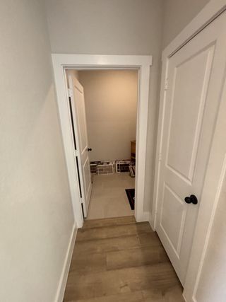 A functional space with tile flooring, leading to the laundry area with ample storage for household essentials.