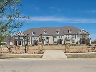Elegant row of homes with charming architecture in the Village on Main Street by Normandy Homes, Frisco, TX.