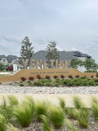 A charming entrance with lush landscaping in Venetian by Megatel Homes (Celina, TX).