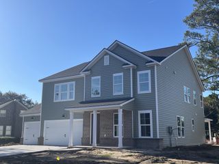 A charming two-story home with a double garage and brick accents in The Oaks by Beazer Homes (Goose Creek, SC).