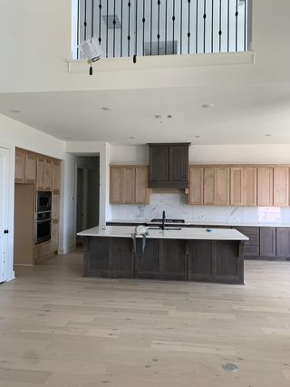 A spacious kitchen with modern cabinetry, an island, and high-end countertops, designed for both function and style.