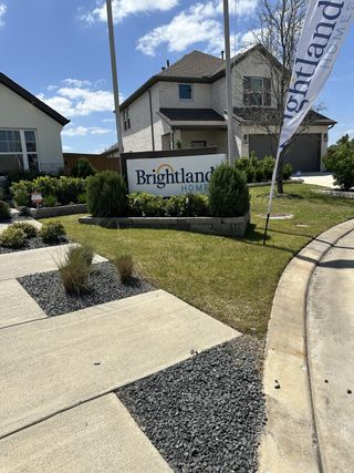 Street view A charming modern home with lush landscape at Cypress Green by Brightland Homes (Hockley, TX).