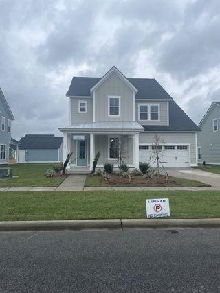 A charming gray two-story home with a manicured lawn in Carnes Crossroads by Lennar (Summerville, SC).