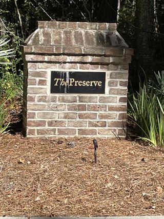 A charming brick sign welcomes you to The Preserve at Pennys Creek by Brightwater Homes in Johns Island, SC.