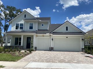 A charming light-blue house with a spacious driveway in Evergreen Island at Silverleaf by David Weekley Homes (St. Augustine, FL).