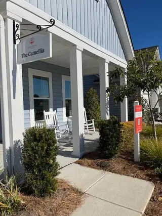 Street view A charming blue home with a welcoming porch in Horizons at Summers Corner by Lennar (Ridgeville, SC).