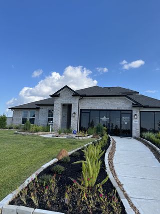 Street view Elegant brick home with manicured landscaping in Lago Mar by Davidson Homes LLC, Texas City, TX.