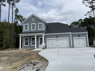 A charming gray two-story home with a spacious three-car garage in Pamlico Terrace by DRB Homes (Awendaw, SC).