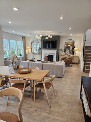 Model Home A warm and inviting living room with a fireplace, shiplap accents, and modern décor for a comfortable yet elegant atmosphere.