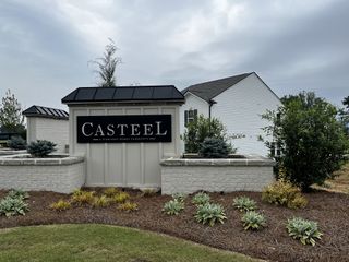 A charming community entrance with manicured landscaping in Casteel by Starlight Homes, Bethlehem, GA.