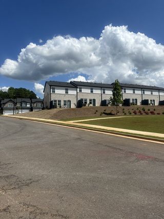 New brick townhomes on a scenic hill in Eagles Hill by Meritage Homes (Stockbridge, GA).
