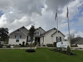 Charming stone and siding home with landscaped yard in Double Eagle Ranch by Scott Felder Homes, Cedar Creek, TX.