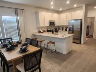 Model Home A stylish dining area with natural light, contemporary furniture, and an elegant setting perfect for entertaining guests.