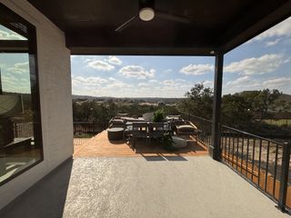 A spacious deck with cozy outdoor seating and scenic views, perfect for relaxation and entertainment.