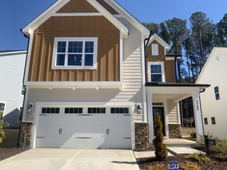 A modern two-story home with stone accents and garage in Carolina Springs: Designer Collection by Lennar (Apex, NC).